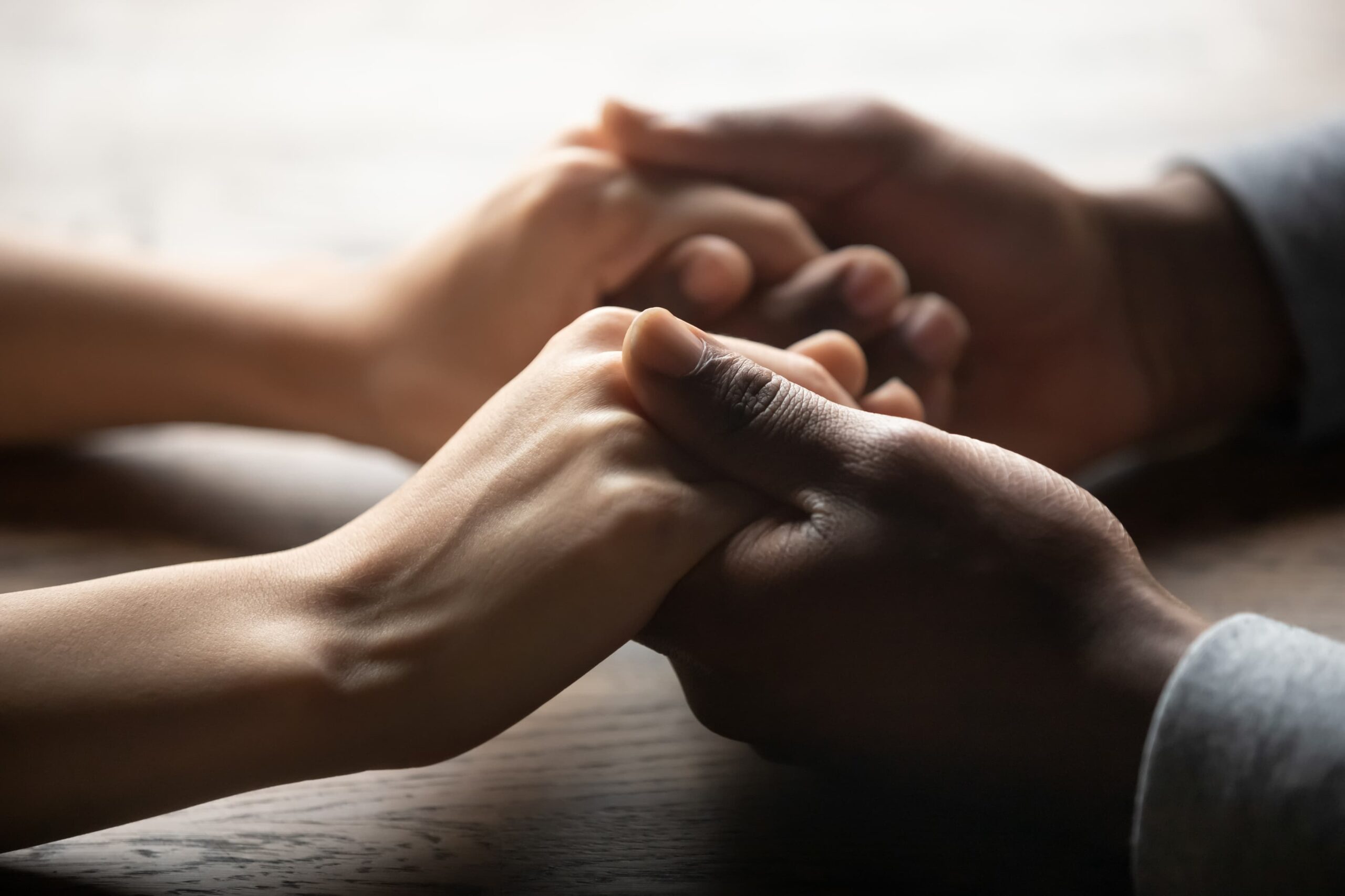 Close-up of couple holding hands showing intimate connection and support
